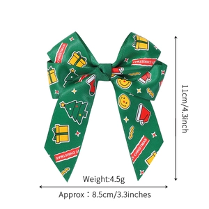 Green Christmas bow hair clip with Merry Christmas ribbon print and festive motifs