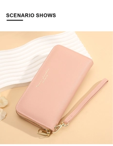 Detail of pink long wallet with cross-pattern texture and gold zipper closure