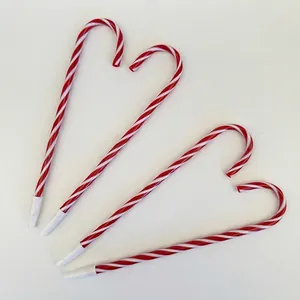 Set of 4 Christmas candy cane shaped pens with red and white spiral stripe patterns