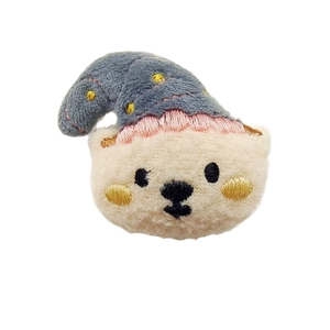 Cute plush bear brooch with blue sleep cap and detailed embroidery on white background