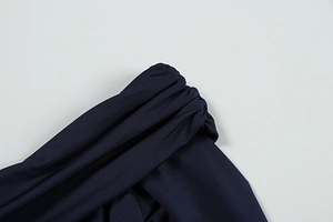 Close-up of the navy blue dress showing ruched fabric and off-shoulder detail