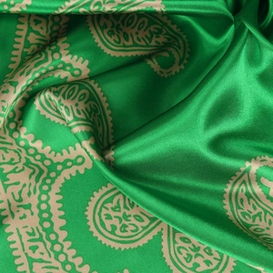 Luxurious green and gold paisley satin silk scarf with elegant draped texture