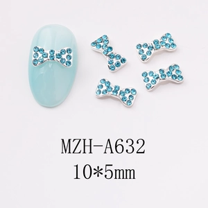 Detailed view of blue rhinestone bow nail charms with silver base and 10x5mm dimensions