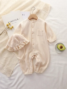 Cotton gauze baby romper with matching ruffled hat and wooden buttons in cream color
