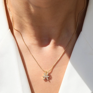 Pisces zodiac necklace in 18k gold plating with micro-pave crystals on model