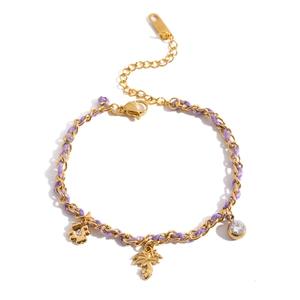 Purple braided cord and gold chain bracelet with flower and palm tree charms