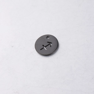 Macro view of a 12mm black stainless steel round charm with Sagittarius hollow design
