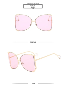 Detail view of square gold-frame sunglasses with pink lenses and pearl temple accents