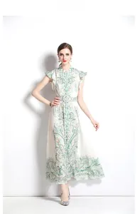 Detail of bohemian paisley dress with ruffled cuffs and matching buckled waist belt