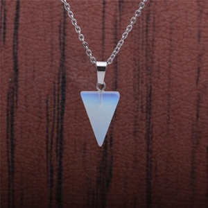 Macro shot of triangle opal stone pendant on a delicate silver metal chain necklace