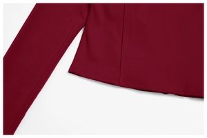 Detail of burgundy yoga top showing professional flatlock stitching and premium fabric seam