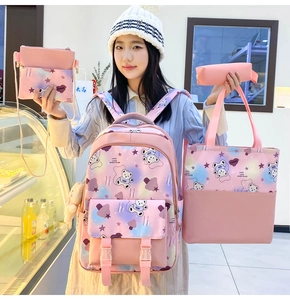 Macro detail of 4-piece school backpack set featuring pink cartoon patterns and accessories