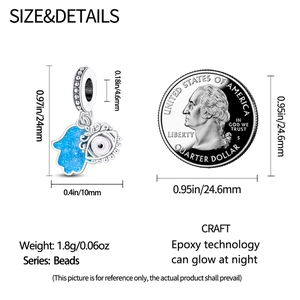 Detailed size comparison of a luminous silver butterfly pendant next to a US quarter coin