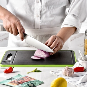 Black multifunctional defrosting cutting board with green border and built-in sharpener
