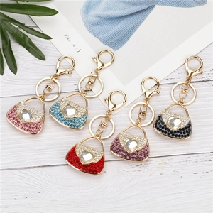 Detailed close-up of colorful rhinestone handbag keychains with heart-shaped crystal accents