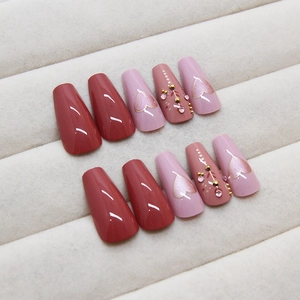 Minimalist heart press-on nails in dusty pink with rhinestones and gold gradient