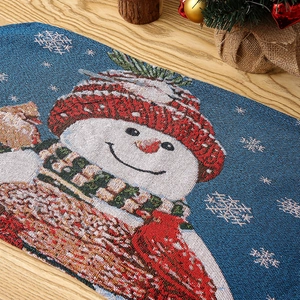 Close-up of knitted Christmas table runner featuring a snowman pattern and jacquard texture