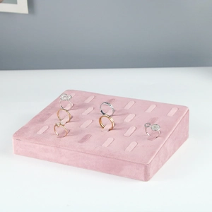 Detailed view of soft pink velvet ring display tray with multiple storage slots