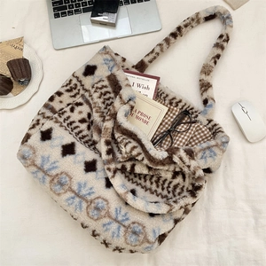 Detailed interior of plush tote bag with plaid lining, laptop, and lifestyle accessories