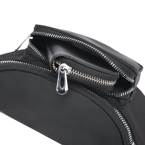 Detail of black waterproof nylon waist bag with multi-layer silver metal zippers