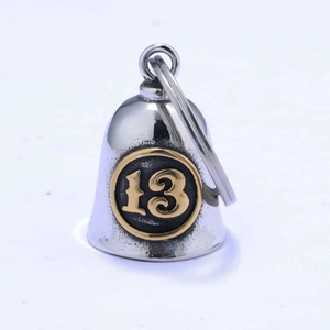 Macro shot of silver retro rider bell featuring lucky number 13 with gold finish
