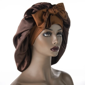 Brown satin sleep bonnet with a large decorative bow and elegant silky drape texture