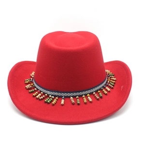 Detail of red fedora hat featuring ethnic woven band and vibrant colorful hanging beads
