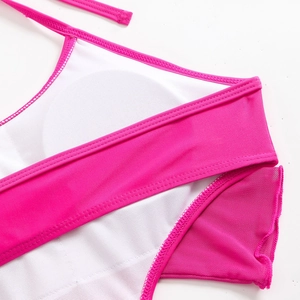 Detail of rose pink swimwear featuring breathable white mesh lining and removable pads