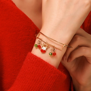 Adjustable Christmas bracelet with reindeer charm and red-green beads on female wrist