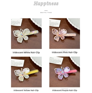 Detail view of colorful acetate butterfly hair clips with sparkling rhinestone center