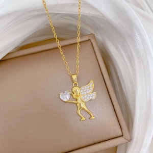 Gold cupid angel necklace with sparkling heart zircon on a premium jewelry box