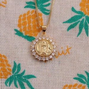 Gold plated box chain necklace featuring a zircon encrusted religious pendant charm