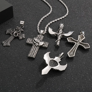 Detail of five silver gothic pendants featuring winged crosses and heart shield designs