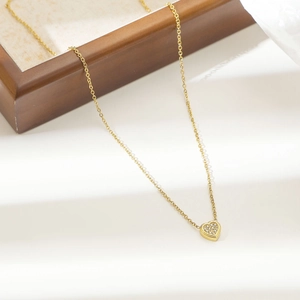 Japanese style gold heart pendant necklace with full pavé crystals on jewelry box
