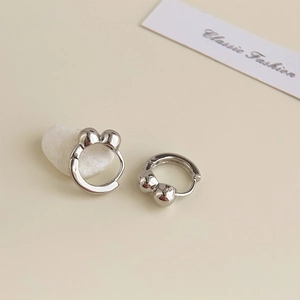 Detail shot of silver double-bead earrings on a card with decorative white stones
