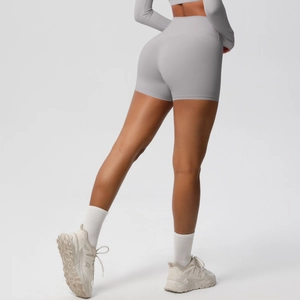 Detail showing grey high-waisted yoga shorts with seamless contouring and peach lift effect