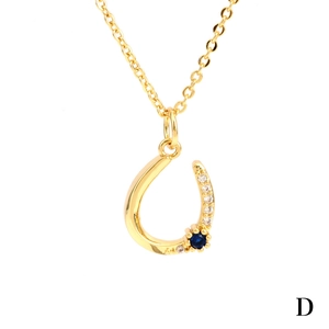 Elegant gold U-shaped horseshoe necklace with blue gemstone and white zircon stones