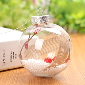 Close-up of 8cm clear Christmas ball filled with red berries and snowy foam details