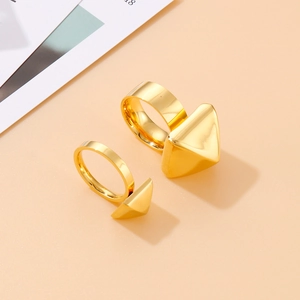 Set of two minimalist golden triangular geometric rings in a polished stainless steel finish