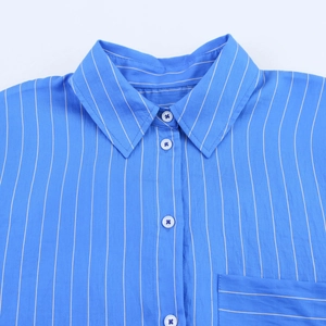 Detail of blue vertical striped shirt showing collar, white buttons and pocket texture