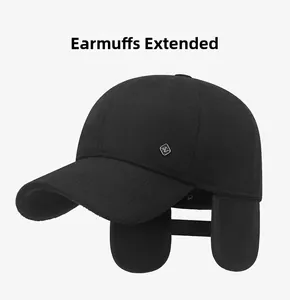 Detail view of winter baseball cap with fold-down earflaps and metal logo accent