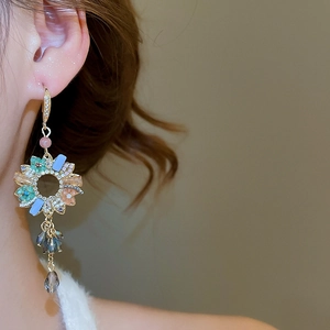 Detail of floral zircon tassel earrings with multicolor gems and crystal beads