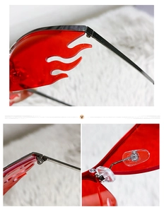 Detail view of flame-shaped red sunglasses showing metal hinges and silicone nose pads