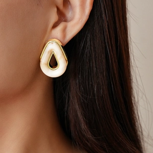 Close-up of marble pattern resin teardrop earring with gold-tone metal frame on model