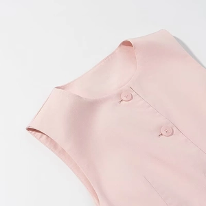 Pink sleeveless top with textured knit fabric and round buttons shown in side detail
