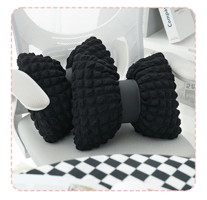 Detail of creative black puff lattice lumbar pillow with wavy texture on a white chair