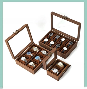 Detail view of walnut wood watch storage box with transparent window and bronze clasp