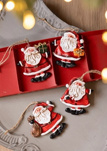 Detailed view of four resin Santa Claus pendants with rustic jute ropes and gift boxes