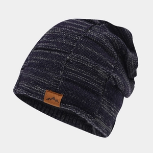 Detail of checkered knit pattern and leather mountain logo on winter beanie cap