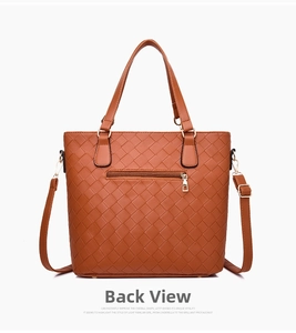 Detailed back view of a brown woven tote bag featuring a zip pocket and gold hardware